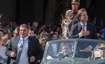 Luis Lacalle Pou el día de su asunción como presidente, con Alejandro Astesiano custodiando a la izquierda