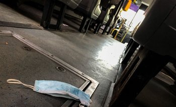 Tapabocas tirado en el piso de un ómnibus