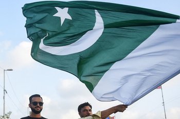 Una persona sostiene la bandera de Pakistán