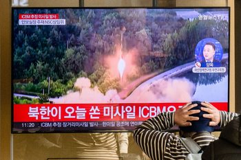 Un hombre mira una transmisión con material de archivo de un misil norcoreano